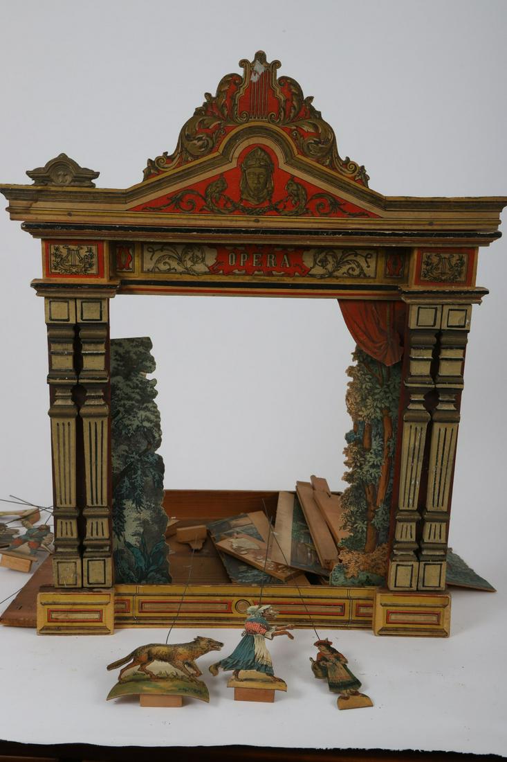 SCHRIEBNER THEATRE "LITTLE RED RIDING HOOD": Hand painted and litho covered wooden stage front. Paper and litho covered figures. 21 x 18 ½ inches. Believed to be by Schriebner but cannot find markings