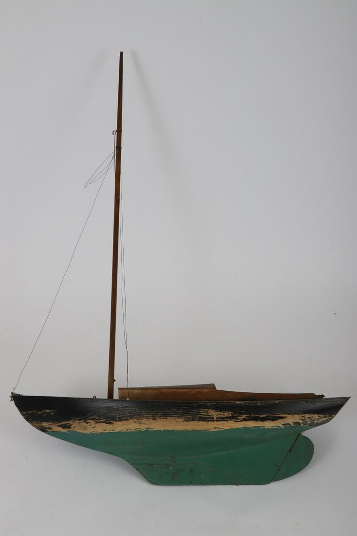 MARBLEHEAD POND MODEL: Carved and painted wood with lead keel. 35 x 24 x 8 inches. Model of the sloop “Harr”. She was a 25-foot sailboat designed and built by Samuel H Brown, Jr. as a college graduation gift to his daug