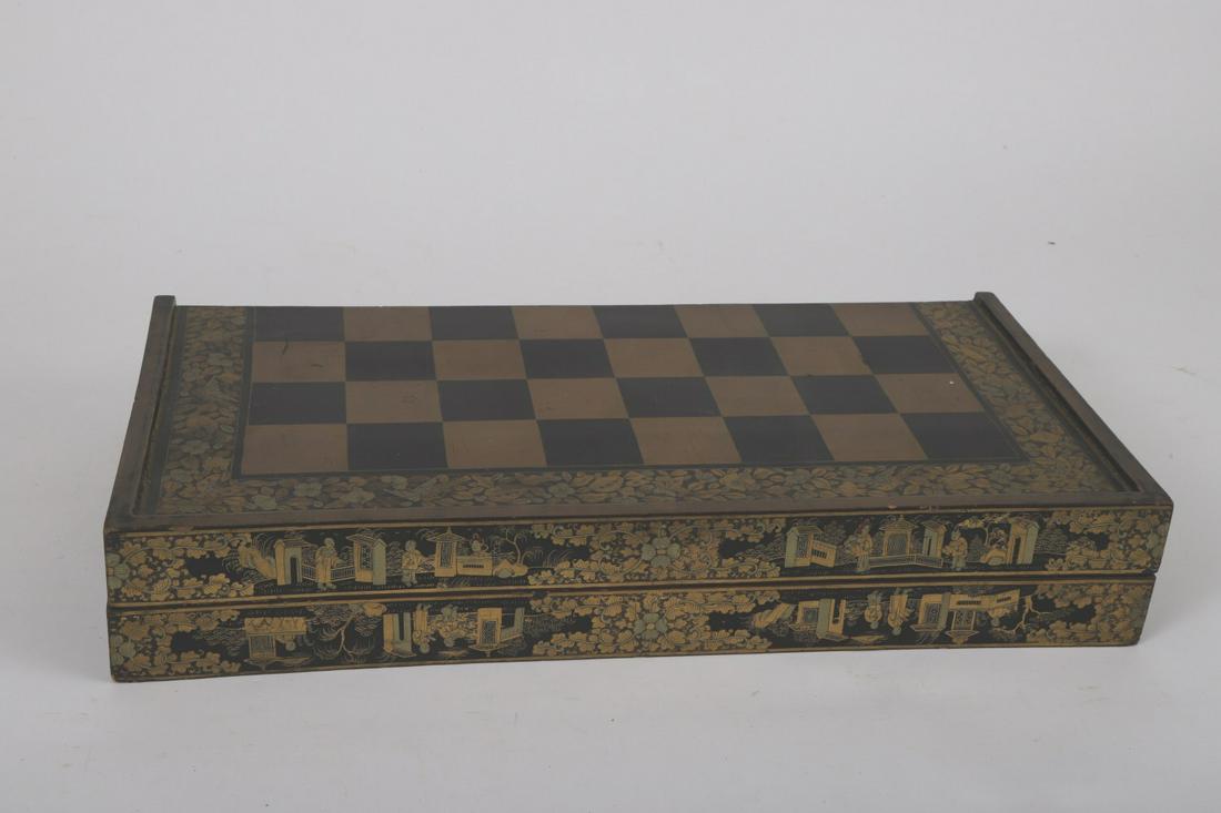 (19th c) CHINESE EXPORT LACQUER GAME BOARD: 3 x 19 ½ x 9 ½ inches. Together with leather shakers.