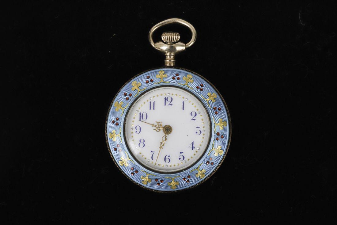 SWISS ENAMELED LADIES PENDENT WATCH: Guilloche work set with intricate gold filigree and faceted rubies over sterling case. 1 ¼ inch (case not including stem)