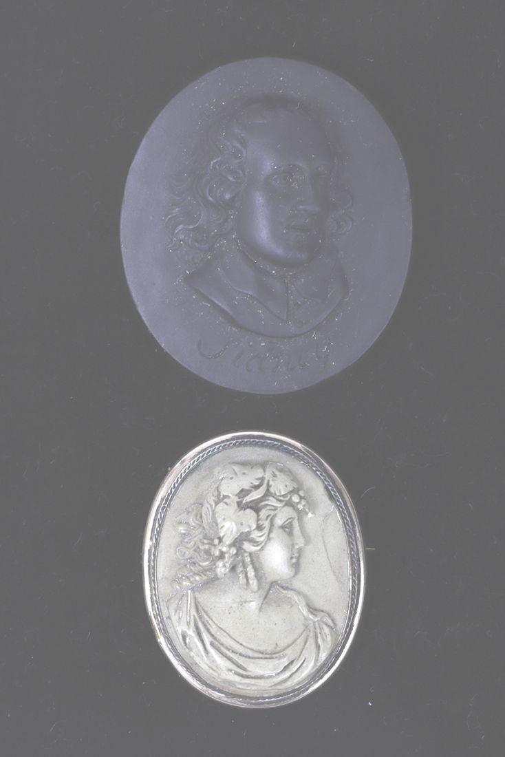 VICTORIAN BASALT MEDAL of SIDNEY & LAVA CAMEO: “Sidney” in black basalt (unmounted) and a lava cameo of a woman set into a gold filled brooch. 1 7/8 and 1 ½ inches