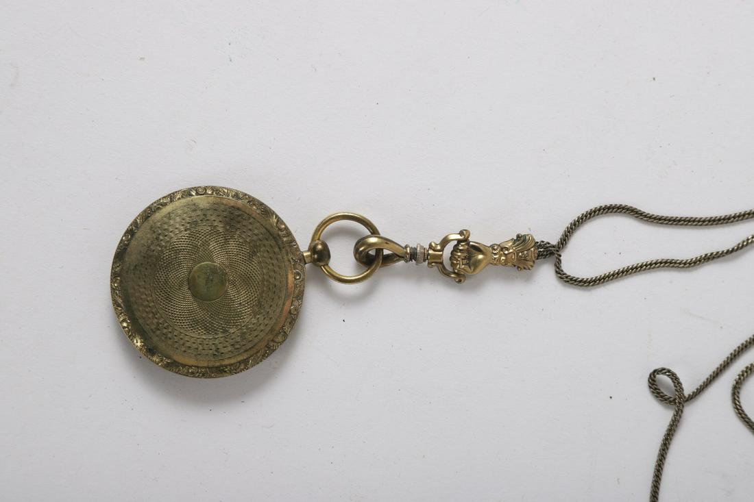 GOLD FILLED PENDENT LOCKET with DAGUERREOTYPE: Foliate bezel with guilloche work case containing a 1 ¼ inch daguerreotype of a gentleman. Together with a 48 inch chain with figurative locking clasp in which to wear it.