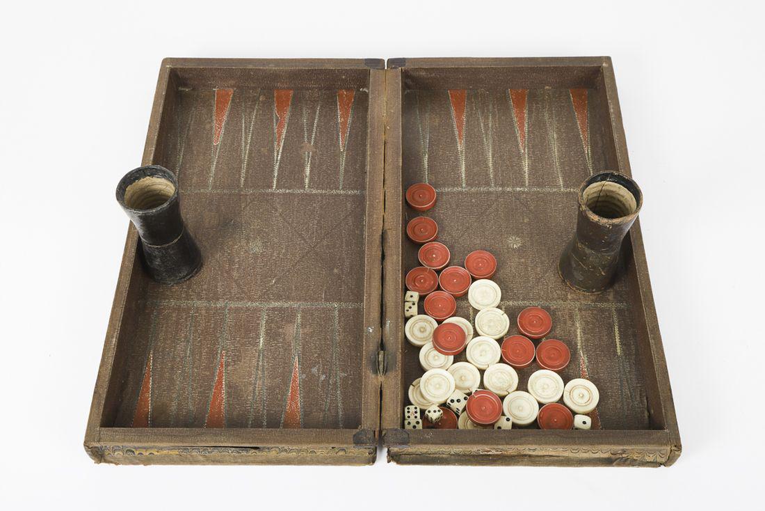 FAUX SCRAP BOOK GAME BOARD with CHECKERS: And backgammon. 14 x 7 ½ inches (closed). 14 white and red checkers, leather shaker and (9) dice.