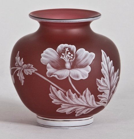 Thomas Webb & Sons art glass cameo vase.: Thomas Webb & Sons art glass cameo vase. The bulbous vase with flared rim in deep rose ground with white floral decoration, circular mark on bottom, signed GEM. Height: 4 1/4 in.
