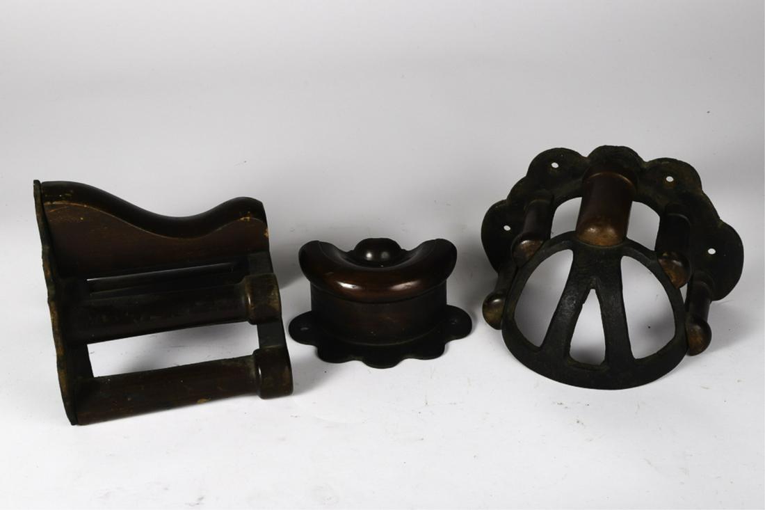 (3) CAST IRON AND WOODEN BRIDLE BRACKETS: Unmarked. 7 x 7 x 8 inches (and smaller). Provenance: W.R. Haughton Stables
