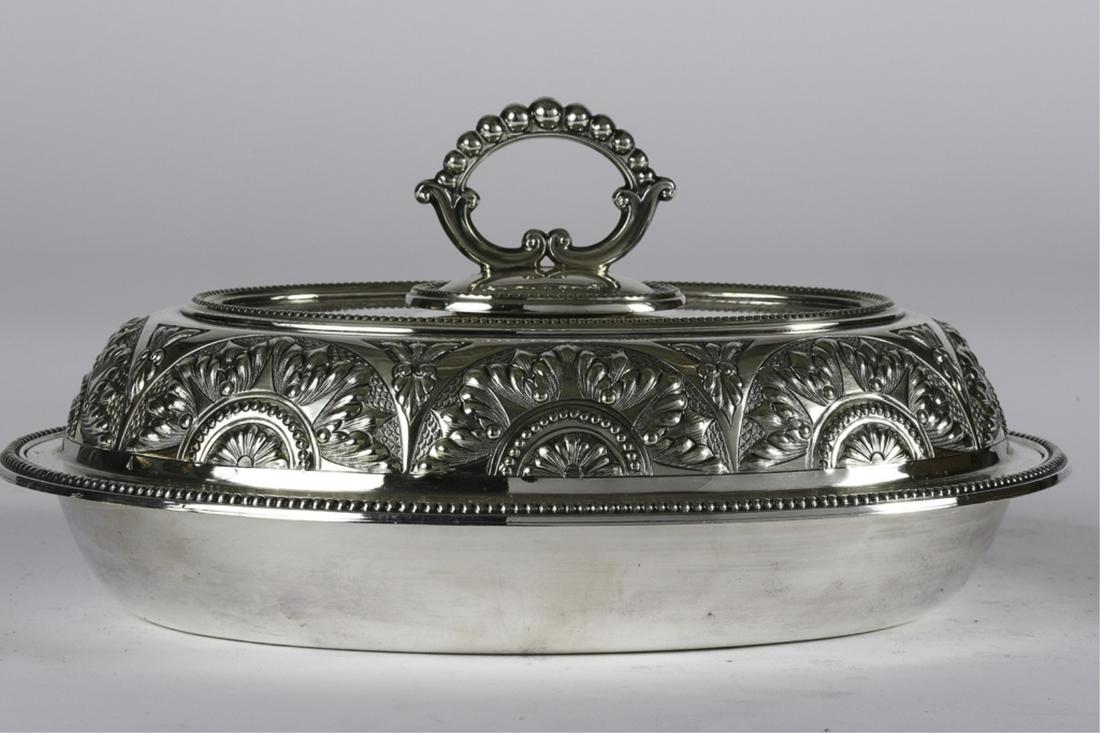 1968 HTA CHAMPION "RUM CUSTOMER" PRESENTATION DISH: William Hutton & Sons silver plated covered dish with beaded handle and repeating floral pattern. 5 1/2 x 10 1/2 x 7 3/4 inches.