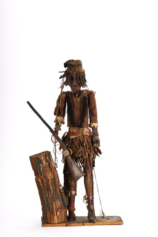 CARVED & PAINTED SCULPTURE of a NATIVE AMERICAN: Hand made clothing, jewelry and rifle. wood, cloth, metal and leather. 23 1/2 inches
