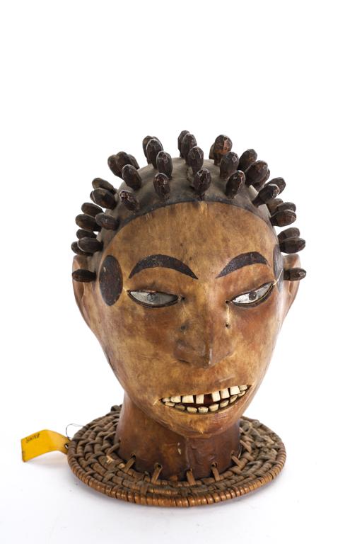 UNUSUAL DAN DANCING MASK of LIGHT MATERIALS: (Turn of the 19th/ 20th c) Finely made from a hollowed light wood. The exterior is covered with stretched animal skin, glass eyes and bone teeth with painted face and hair with individual carved curls