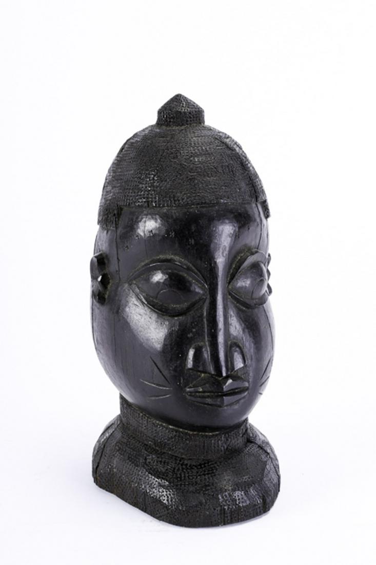 (Early 20th c) CARVED BUST of a BENIN CHIEFTAIN: Heavy de-like dark red wood with traditional cap and neck adornments. 12 1/2 inches