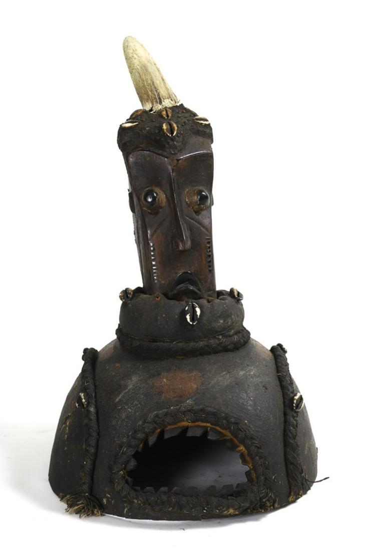 WEST AFRICAN POSS. NIGERIAN DANCING HELMET MASK: (20th c) Depicting a human with a horn-like protrusion and decorated with cowry shell and braided rope design. Made from a gourd. Head is made of pottery material.