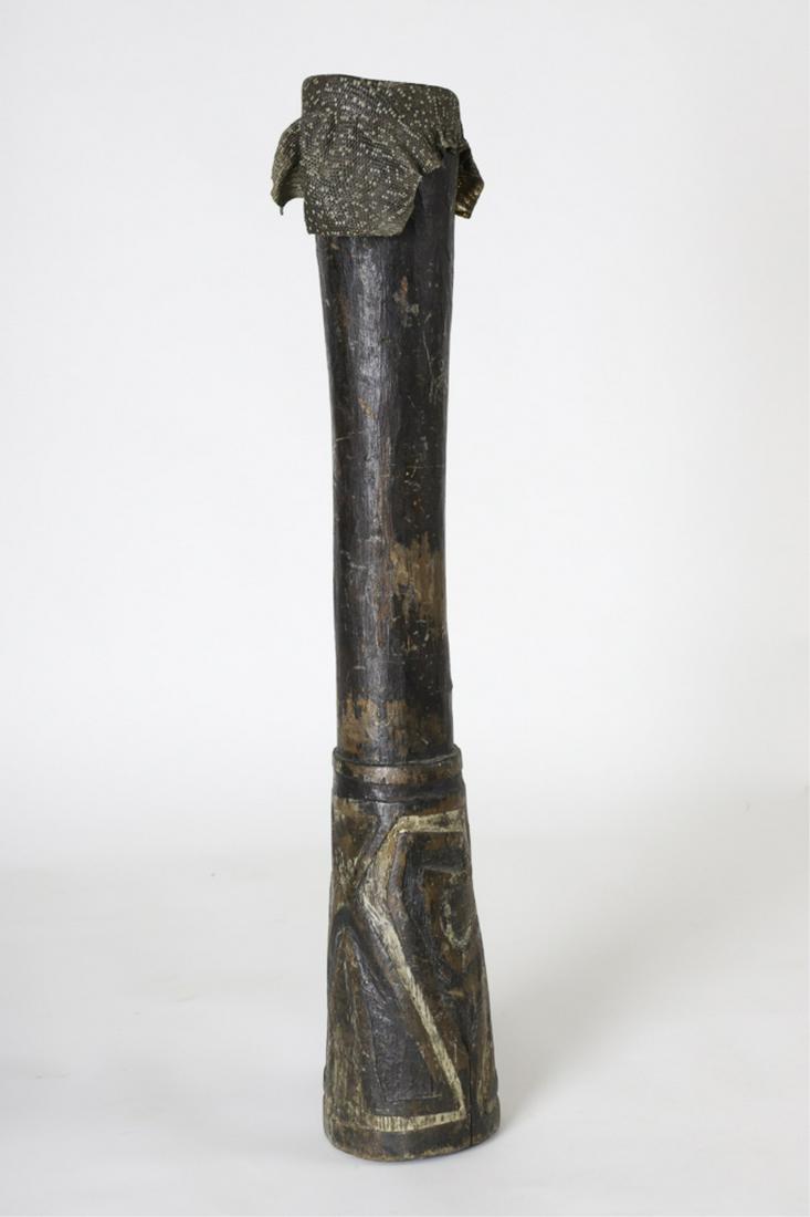 EARLY WEST AFRICAN CARVED & PAINTED DRUM: From a hollowed log the base was carved with geometric patterns. Snake skin head. 29 1/4 x 5 1/4 inches