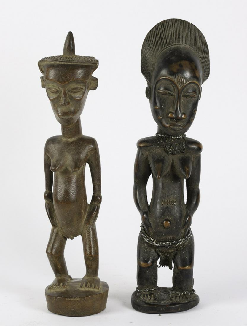 (2) CENTRAL AFRICAN FIGURES OF STANDING FEMALES: Including: (Early to Mid 20th c) Fine features and glass beads on her legs, neck and waist. The second (Mid 20th c) with her hands by her sides. 18 1/2 inches (and under)