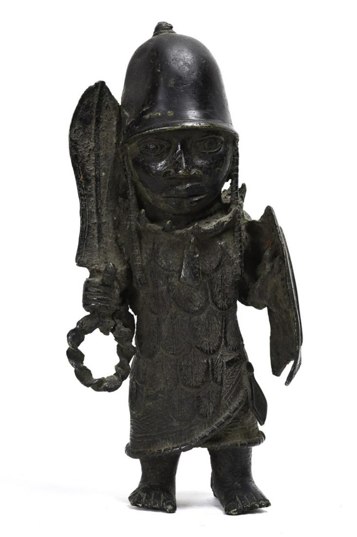 FINE CAST BRONZE BENIN FIGURE (possibly 18th c): Standing warrior holding a sword and shield and clad in reinforced armor. 10 3/4 inches