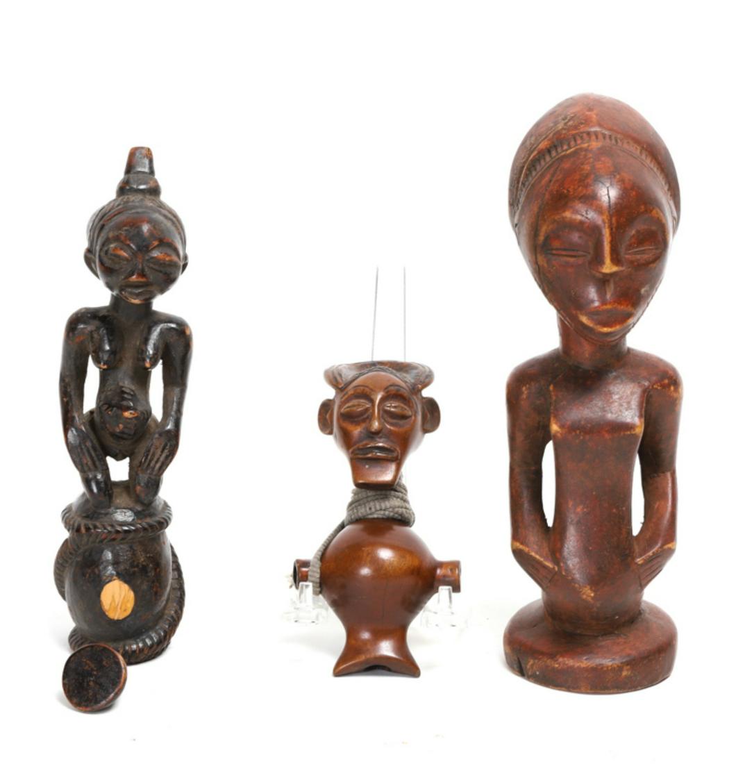 (2) VERY FINELY CARVED AFRICAN FIGURINES etc: (1) Of a female kneeling on a drum with a pronounced belly button of considerable age, the other of a lighter wood with a distinctive hairdo with a suspension cord. Together with a carved wooden figur