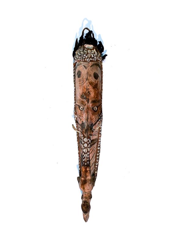 PAPUA NEW GUINEA SEPIK RIVER KOROGA MASK: Carved and painted wood with an elongated anthropomorphic face. Shell inlay and tusk accents. 27 inch height