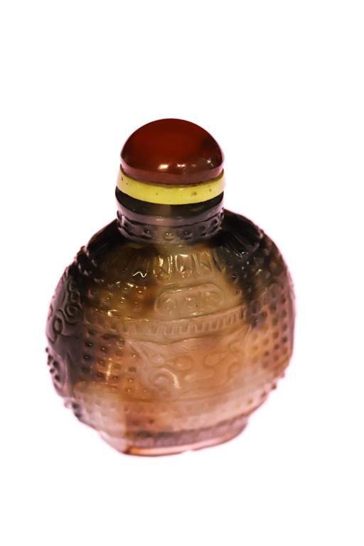 CHINESE BROWN & WHITE JADE SNUFF BOTTLE: Carved in relief with hobnail ground and stylized cats. unsigned. 2 1/2 inches.