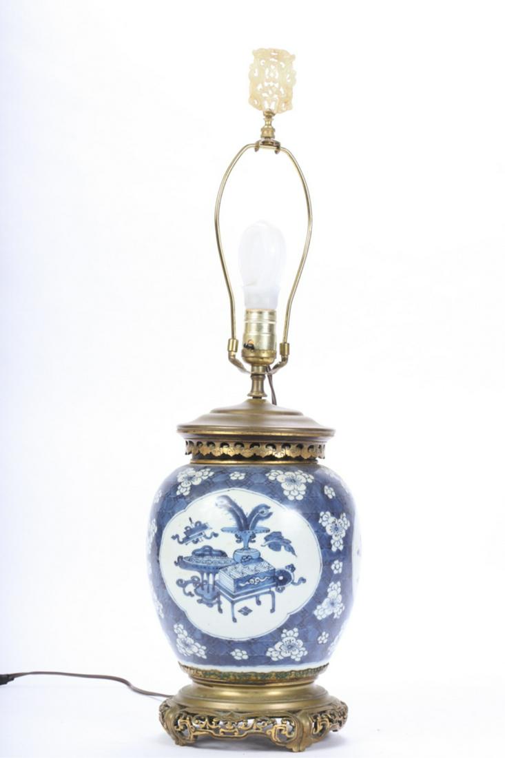 CHINESE BLUE AND WHITE GINGER JAR LAMP: Pierced bronze base and cover with pieced jade? plaque finial. 16 1/2 inches (to top of socket). Plaque 2 1/2 x 1 7/8 inches.