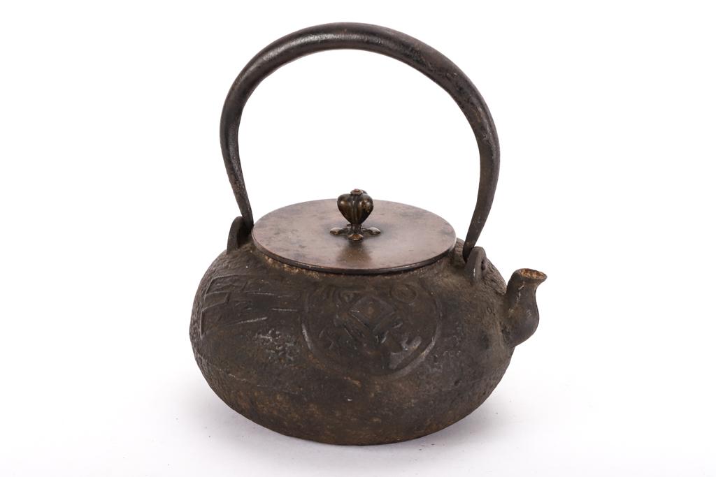 JAPANESE IRON SWING HANDLE TEAPOT with BRONZE LID: Cast with raised geometric designs. signed under lid. 8 inches (with handle extended)
