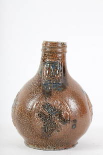 Small Bellarmine Bartmann Bearded Man Jug: Molasses glazed stoneware. 7 inches.