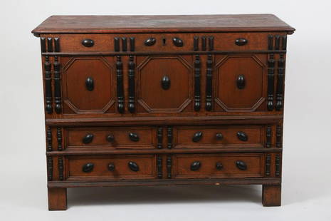 Pilgrim Century Two Drawer Oak and Pine Chest: Three paneled front, each panel octagonal with two drawers below, the front is ornamented by ebonized turned spindles and bosses, original pine lid. Massachusetts circa 1680-1700. 35 ½ x 21 ½ x 48