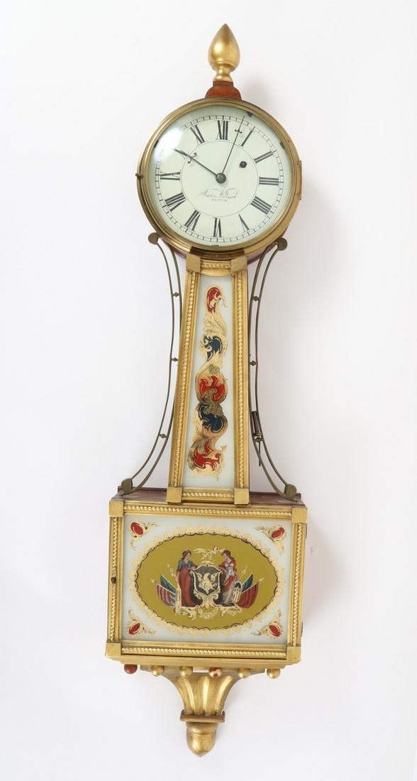 Patriotic Aaron Willard Banjo Clock: 7 ½ inch dial with turned finial, reverse painted and eglomise throat with running rococo motif and tablet with liberty holding a shield with the American Eagle. 40 inches