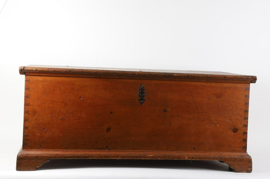 (18th c) Chippendale Blanket Chest: Dovetail construction, lid with huge strap hinges and breadboard ends opens to till, molded base and bracket feet. Early wrought iron escutcheon and lock. 22 x 51 x 23 inches.