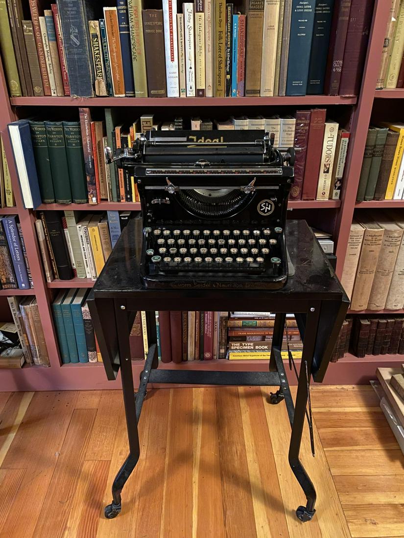 NAUMANN IDEAL S & N TYPEWRITER: Together with stand on casters. 9 x 16 x 12 inches. Stand is 26 inches.