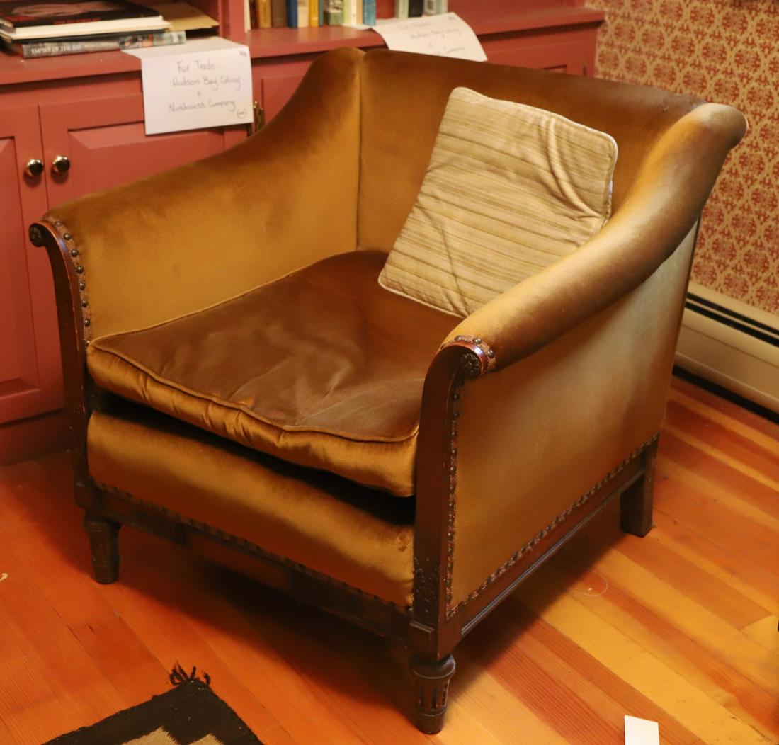 FINE QUALITY LOW UPHOLSTERED CLUB CHAIR: Scrolled arms and paneled frame carved with florets, acanthus leaves and bell flowers. 30 x 32 x 31 inches
