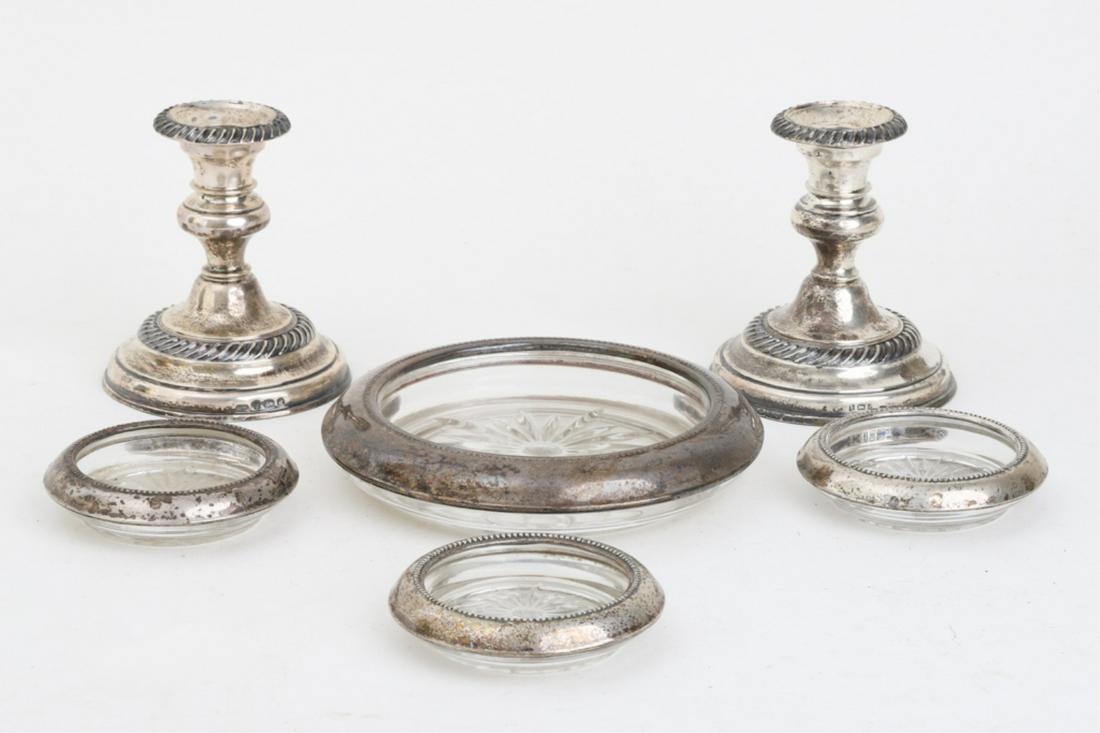(4) STERLING SILVER COASTERS & CANDLESTICKS: Candlesticks are British. Largest coaster is 7 inches. Candlesticks are 4 1/2 inches