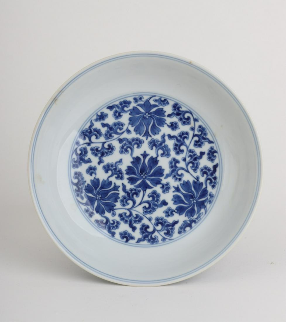 CHINESE BLUE & WHITE PORCELAIN BOWL: Floral decorations surround the outside of bowl with the same in the basin. 2 x 7 1/2 inches.