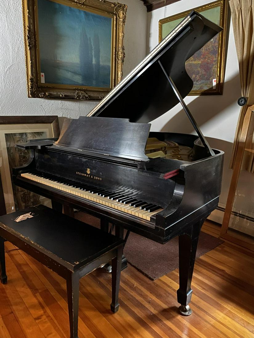 1912 STEINWAY GRAND PIANO: Serial number: 156402 Steinway model M 5'7". Satin ebony finish. Case is weathered with craquelure, crazing. Action appears to be original with the exception of the hammers. Keys have been recovered w