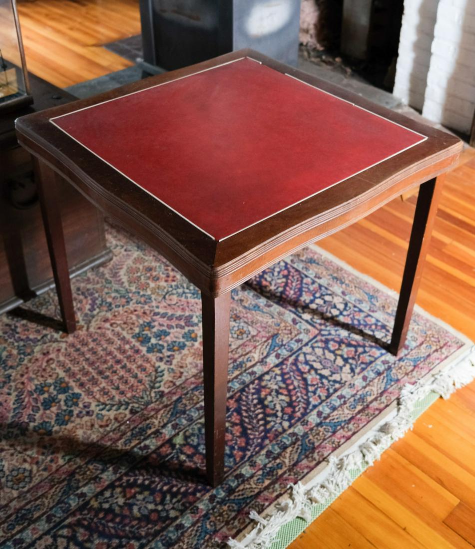 FINE QUALITY MAHOGANY FOLDING CARD TABLE: Molded ogee top inlaid with synthetic plastic with a harder Bakelite ? white trim. 28 1/2 x 32 x 32 inches