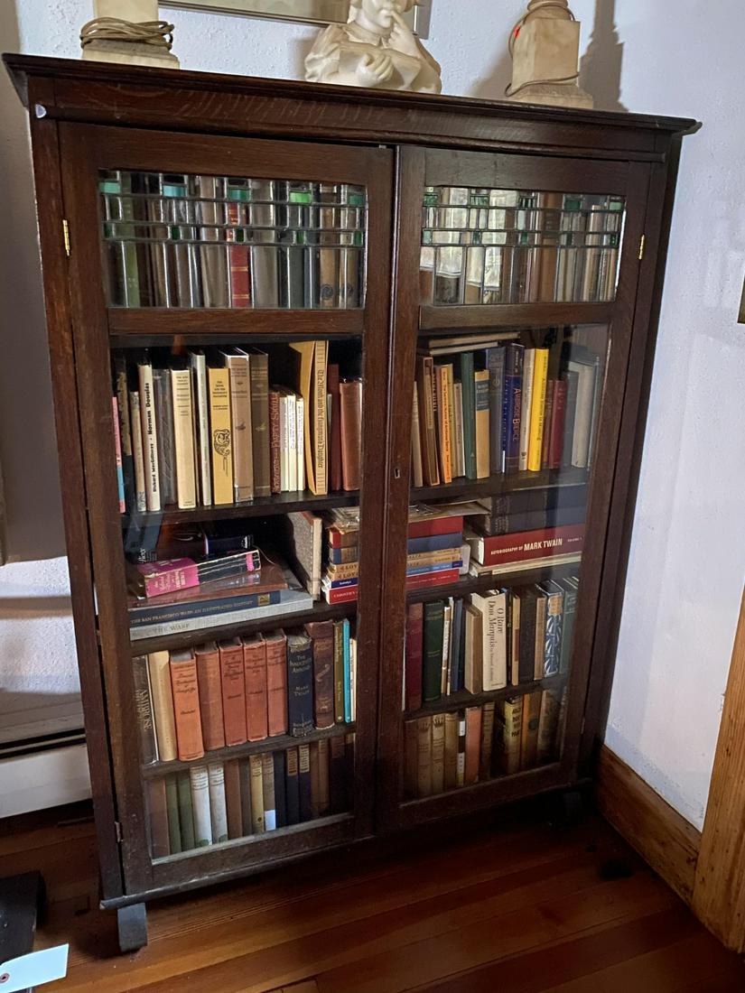 ARTS & CRAFTS STYLE LEADED GLASS OAK BOOK CASE: Molded top with (2) glazed doors with leaded panes open to (4) adjustable shelves. 57 1/2 x 42 inches.
