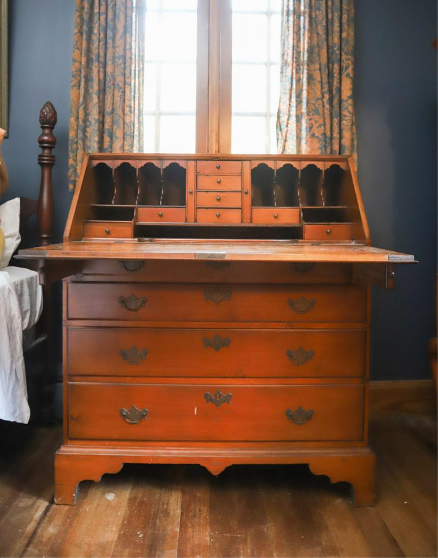 CHIPPENDALE CHERRY FALL FRONT DESK: Molded fall front opens to an array of drawers and shaped pigeon holes above (4) graduating molded drawers, molded base with bracket feet and center shaped drop. 42 1/2 x 36 x 18 inches.
