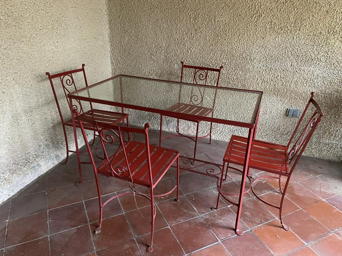 WROUGHT IRON and GLASS PATIO TABLE and (4) CHAIRS: Fine quality, strap seats and penny feet. Table measures 29 x 48 x 26 inches.