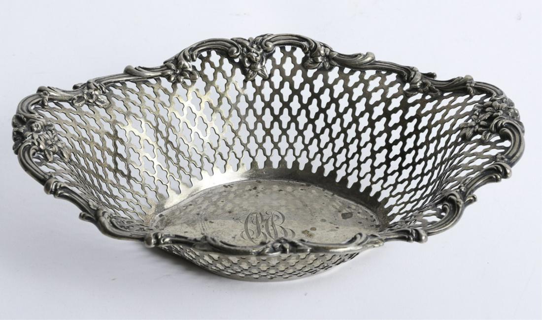 F.A. ROBBINS COMPANY STERLING SILVER BASKET: Lobed oval reticulated basket with a rococo inspired floral rim. 2 1/4 x 7 x 9 inches. 10.27 troy ounces.