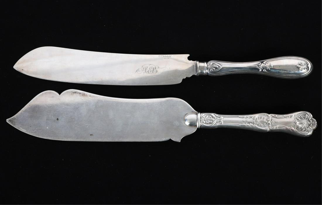 (2) STERLING & COIN SILVER CAKE KNIVES: Including: Gorham example with nicely shaped blade and shell embossed handle. The second is marked John C. Farr & Company patent 1846 with a coin silver (tested) handle. 12 1/2 and 12 1/4 inches. 5.62