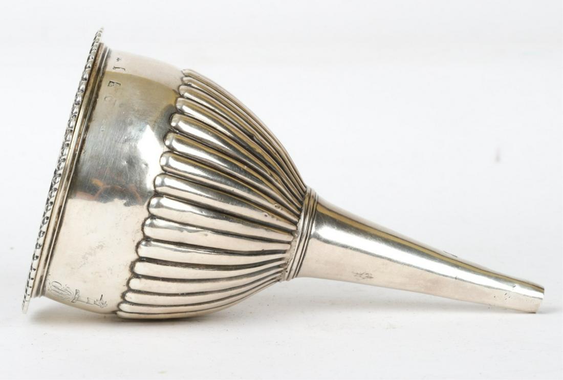 (19th c) STERLING SILVER WINE FUNNEL & STRAINER: In (2) pieces. Ribbed funnel and strainer with a petaled rim. makers mark illeg. Date stamped 1895. 5 7/8 inches. 4.79 troy ounces.