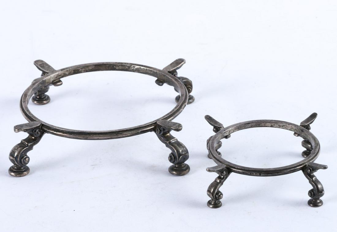 (2) LIONEL ALFRED CRICHTON STERLING SILVER TRIVETS: Matching pair with rings fitted for 5 1/2 and 3 1/4 inches. 16.27 troy ounces
