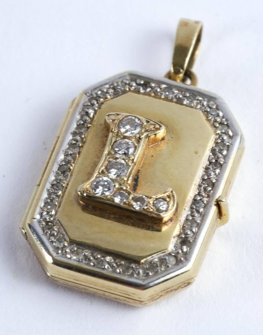 14k GOLD & DIAMOND LOCKET MADE IN GERMANY: Pendant locket opening to (2) frames. 3/4 x 1/2 inches. 2.6 dwt