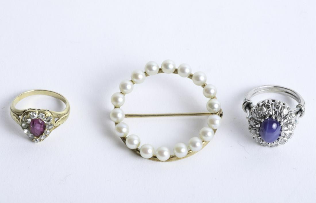 TWO 14k GOLD RINGS and a 14k GOLD PIN: Including: Rose gold set with ruby surrounded by diamonds in the form of a heart. size 3 1/2. A white gold basket set with cabochon cut lapis surrounded by diamonds size 3, and a round pin set with pe