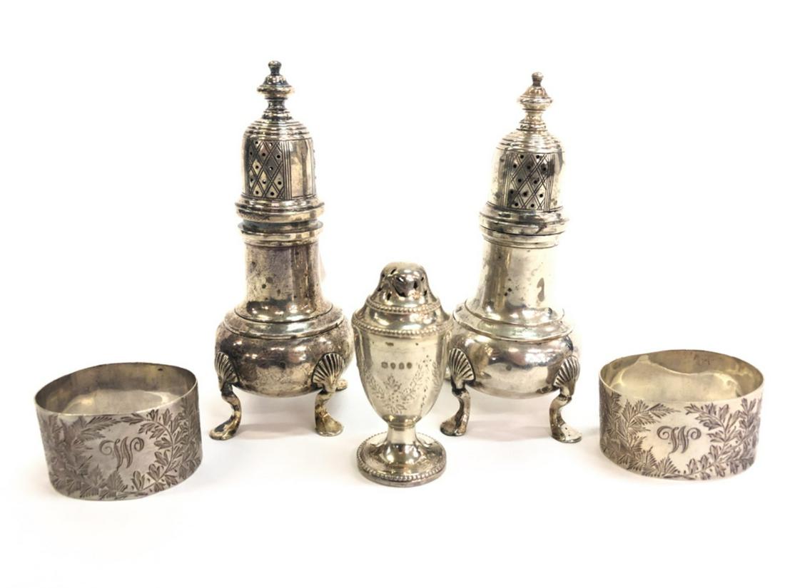 (5) PIECES OF STERLING SILVER SALTS & NAPKIN RINGS: Including: Pair of footed castors with shell knees marked sterling, a British urn-form example with floral swags and bell flowers dated 1876 and a pair of napkin rings bright-cut with floral motifs. 8