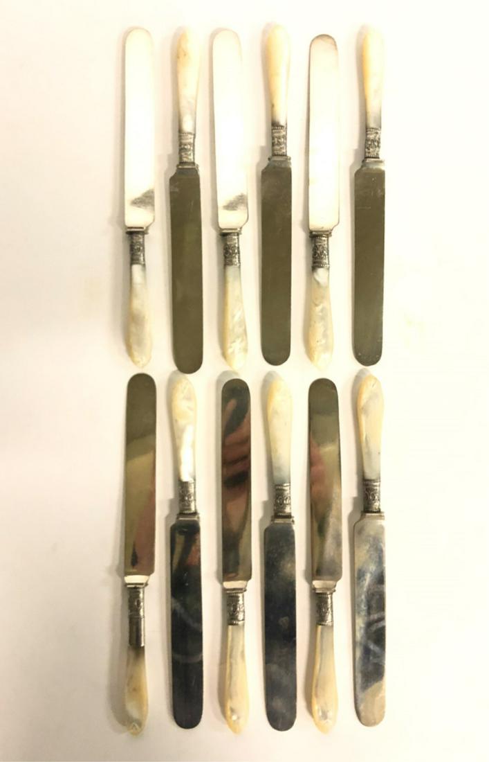 SET OF (12) J. RUSSELL & CO DINNER KNIVES 1834: Carved mother of pearl handles and collars embossed with silver filigree. 9 1/8 inches.