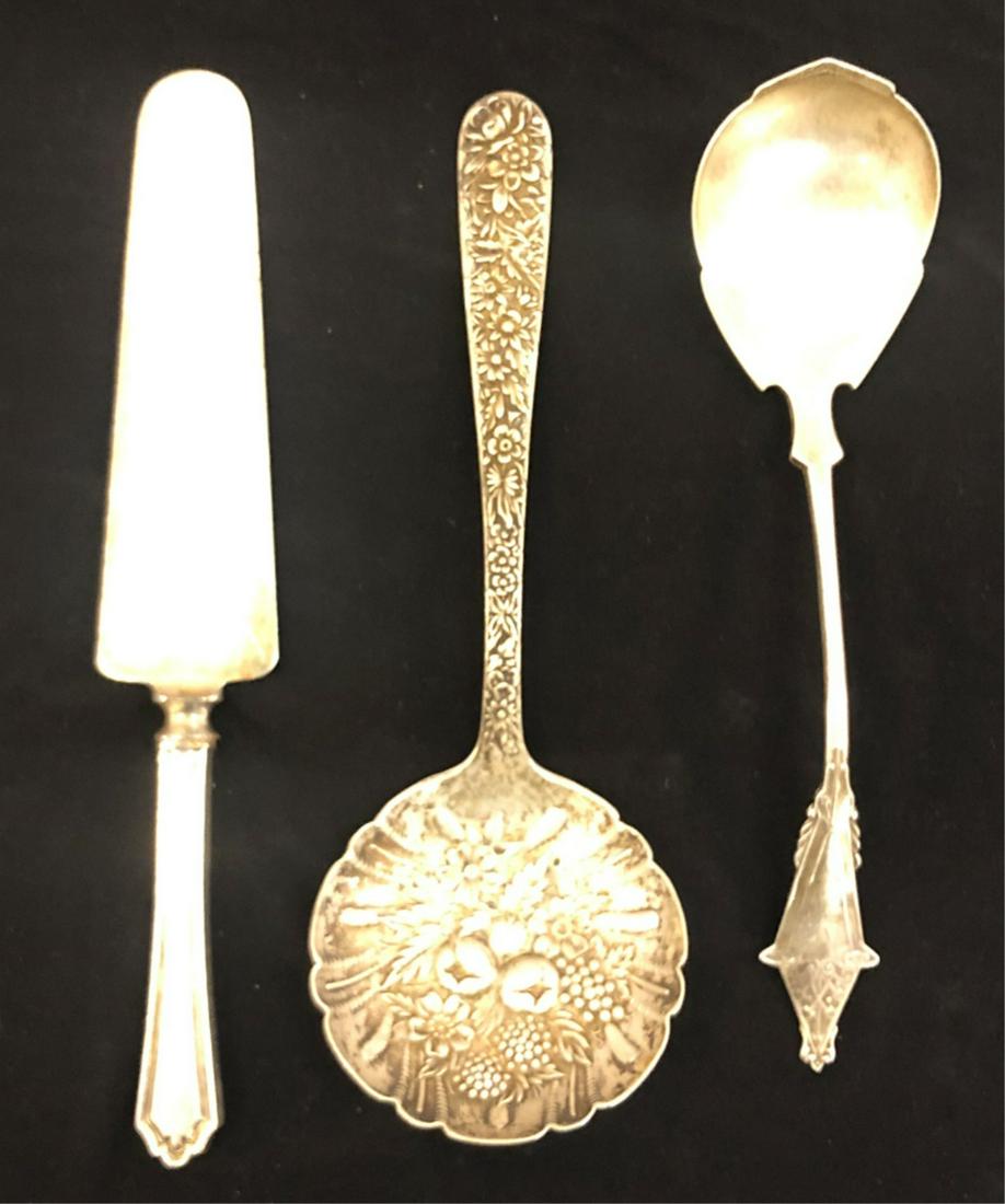 KIRK STERLING SILVER BERRY SCOOP & SERVING SPOON: S. Kirk and Bow Co scoop with floral hand chased bowl and embossed handle. The second sterling silver aesthetic movement serving spoon is not signed by its maker. 8 1/2 and 9 inches. Together with a p