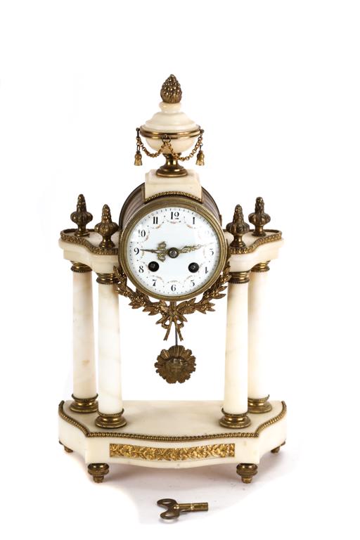 FRENCH WHITE MARBLE PORTICO CLOCK: Hand painted 4 1/2 inch porcelain dial with chiming movement. Brass case supported by a portico of white marble with ormolu mounts. Surmounted by urn finials. Movement signed Medaille D'argent Vincent