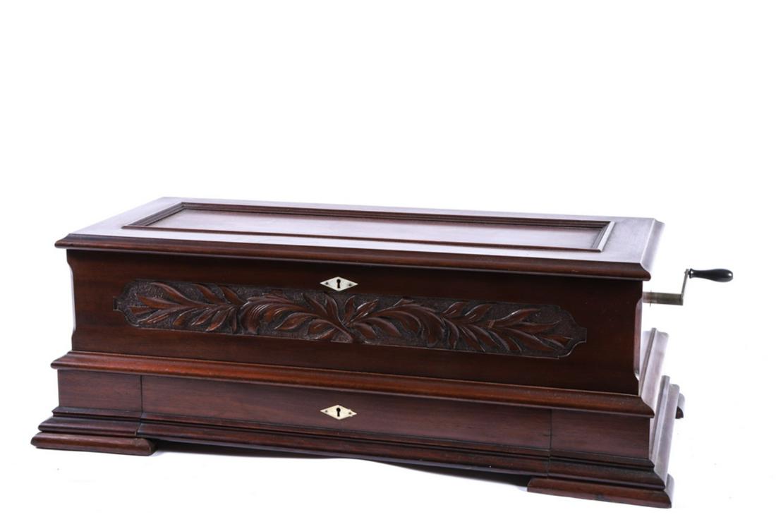 LARGE JACOT IDEAL SAPRANO MUSIC BOX: Swiss movement patented 1890. Carved mahogany case and (6) interchangeable 14 1/2 inch cylinders. 12 x 34 x 15 1/2 inches. Serial number 122 356