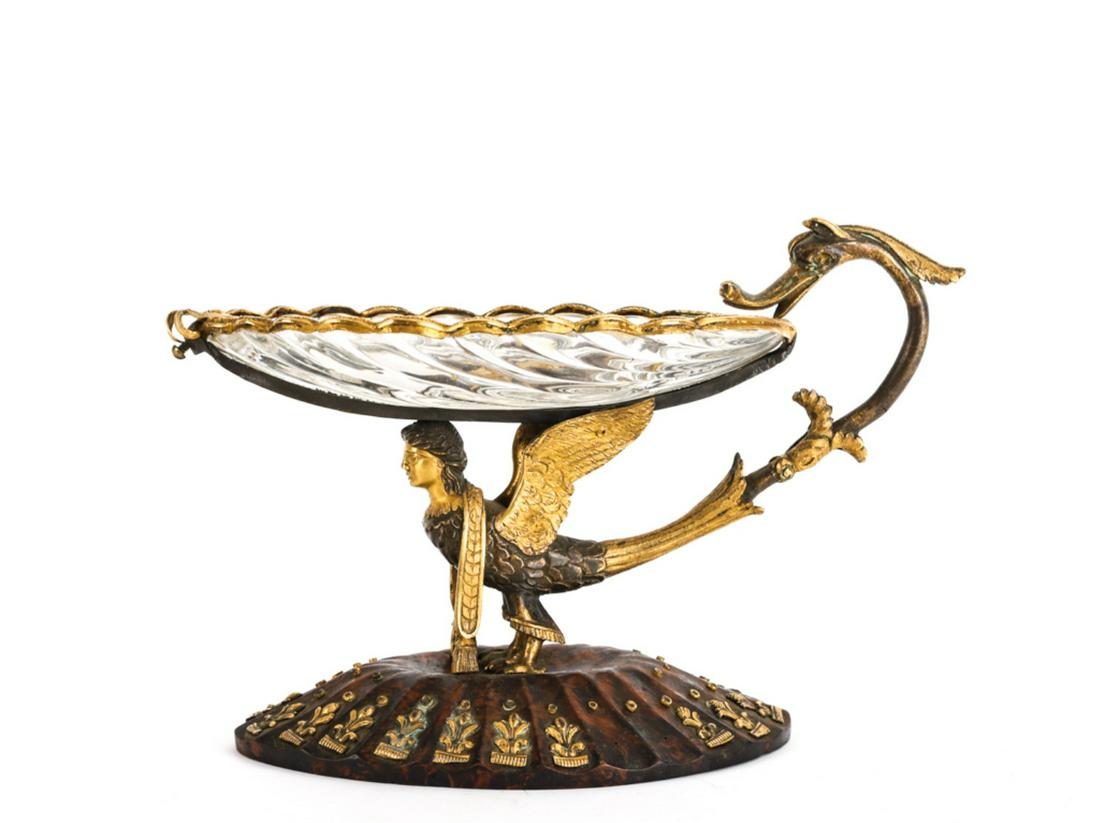 (Early 19 c) FRENCH EGYPTIAN REVIVAL RAISED DISH: Scalloped crystal dish with ormolu mounted rim, serpent handle and raised on back of a gilt bronze winged sphinx. Scalloped burl base is set with fleur-de-lis and rings. 7 x 10 x 4 3/4 inches.