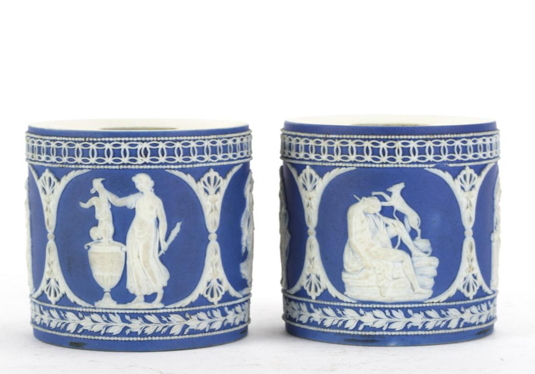 (2) ADAMS BLUE AND WHITE JASPERWARE CYLINDERS: Each different depicting classical figures and animals. signed Adams. 2 1/2 x 2 1/2 inches.