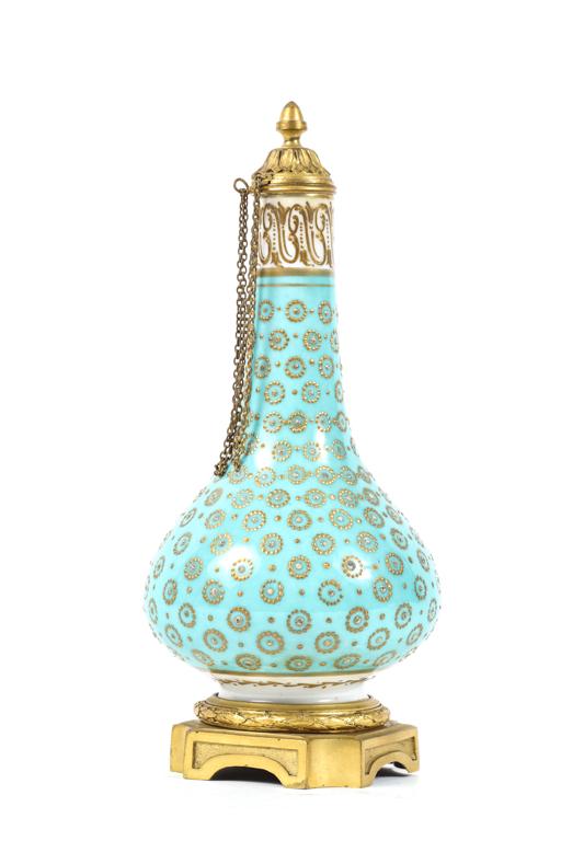 CONTINENTAL PORCELAIN PERFUME with ORMOLU MOUNTS: Fitted with chained stopper and raised base. Hand painted with scrolled neck and gold and white dotted circles. unmarked. 7 3/4 inches.