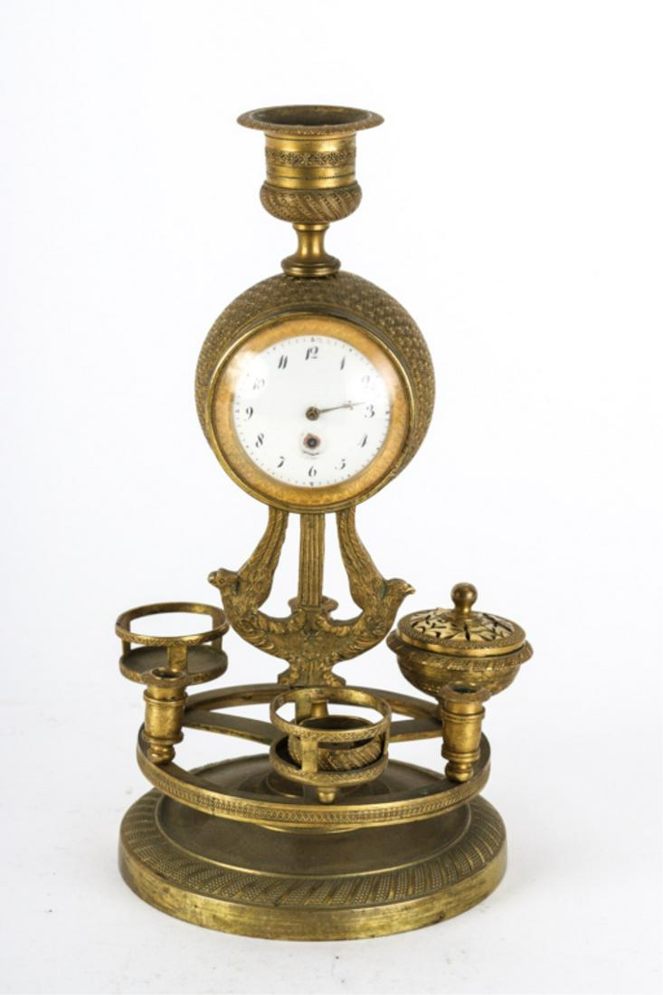 NAPOLEONIC L'INGENIER CHEVALIER PARIS DESK CLOCK: Global gilt bronze case incorporated into a candlestick and Lazy Susan with sockets for candles, ink and other desk accessories. 9 inches.